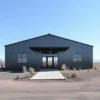 Graphite metal building front elevation with central glass entrance and side windows