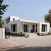 Pure white prebuilt container home, multi-module family residence on a level Indian plot.