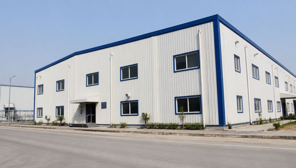 Finished white prefab building with windows and entrance on an Indian industrial estate.