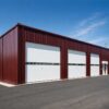 Steel blue prefab industrial building with a glass entrance and office-zone windows.
