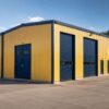 Charcoal prefab industrial building corner showing roller shutter, steel door and window.