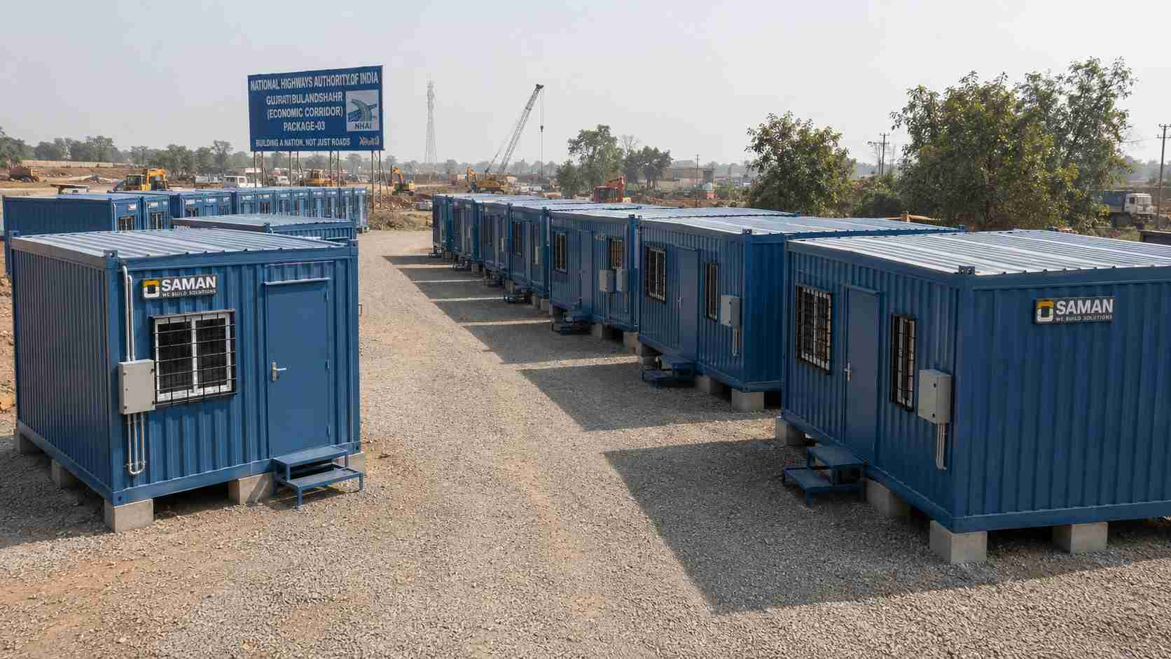 SAMAN prefab labor hutments in Steel Blue arranged across a two-row NHAI highway construction camp.