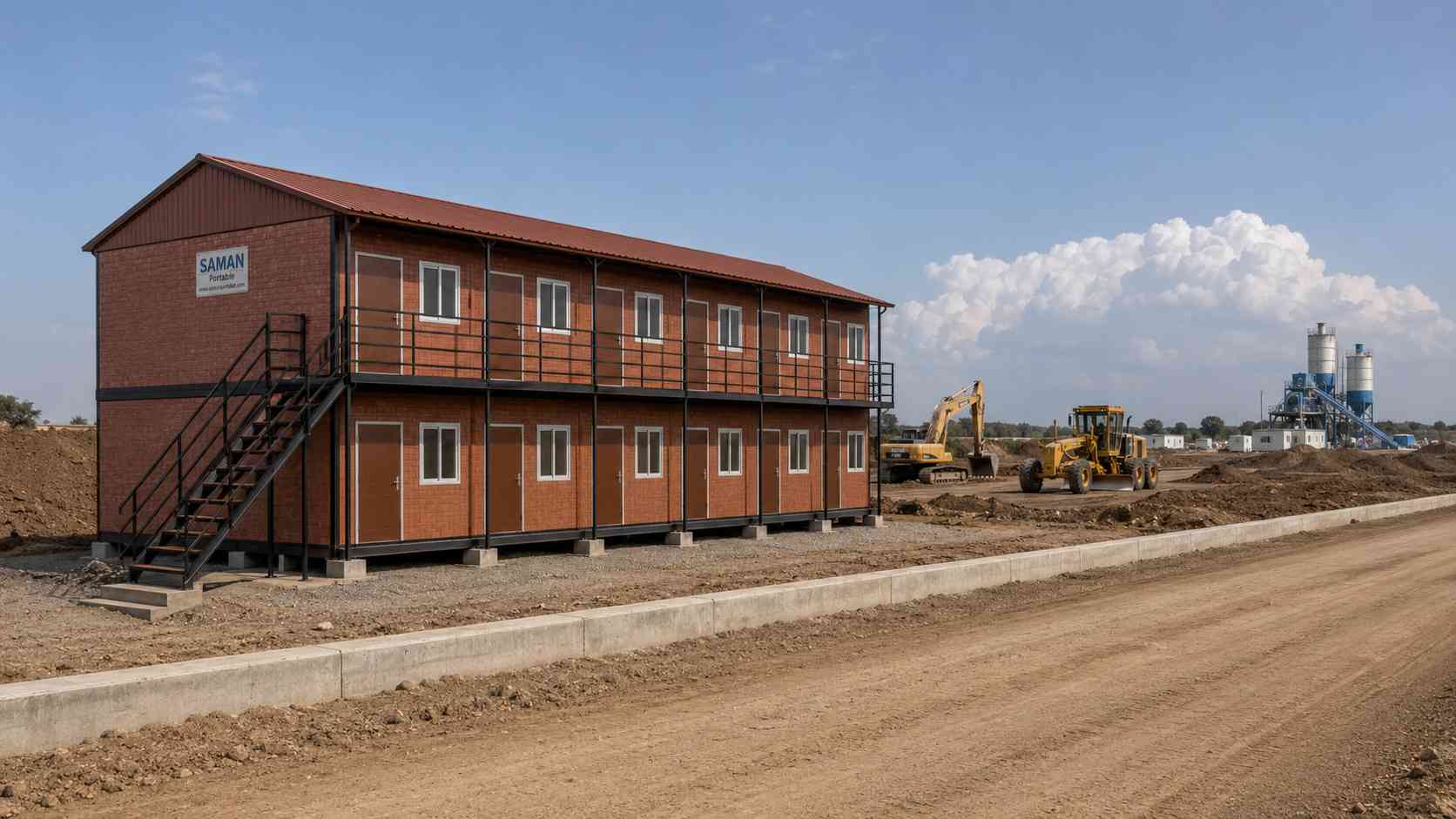 SAMAN prefab labor shed deployed at a highway construction project in India with earthwork berms and a batching plant in the background