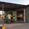 Workers using the recreation block at a prefab labour colony in late afternoon