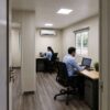 Office team working inside a SAMAN prefab portable office with AC, false ceiling, and partition wall layout