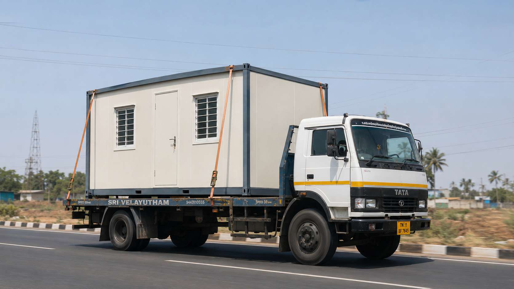 SAMAN prefab portable office being transported as one complete unit on a flatbed truck on an Indian highway