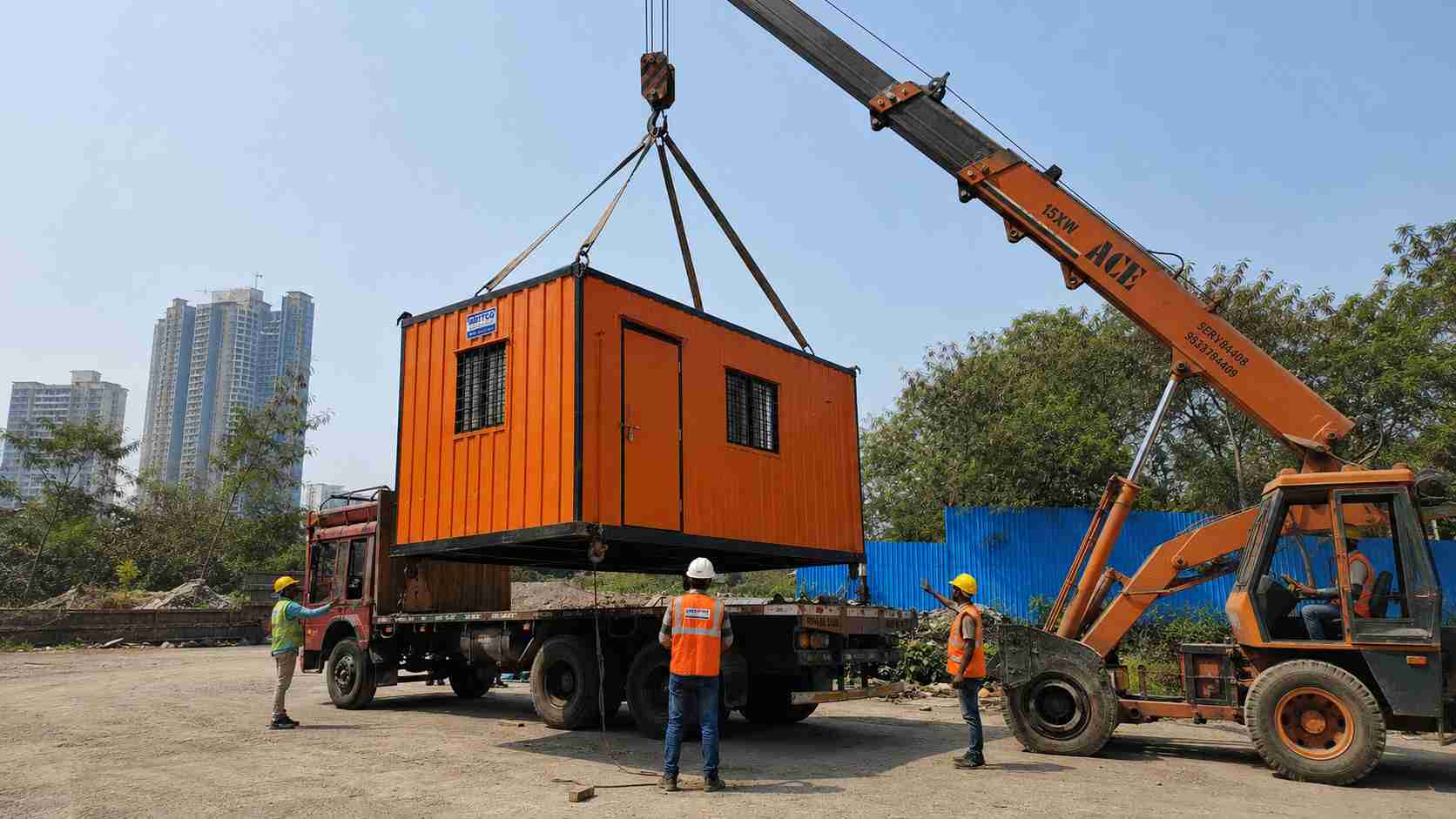 Prefab site office being loaded onto a flatbed truck for relocation to the next project.