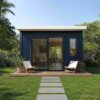 Navy blue front view of a prefabricated container house showing glass sliding doors and patio