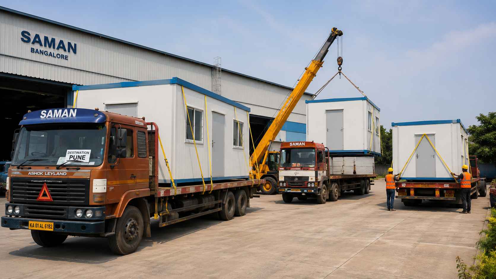 Three flatbed trucks at SAMAN Bangalore yard loading prefabricated office cabins for distributed dispatch