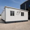 Side view of prefabricated office cabin from a bulk order with two identical cabins behind