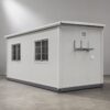 Prefabricated portable office cabin rear exterior view showing AC mounting bracket and ventilation point