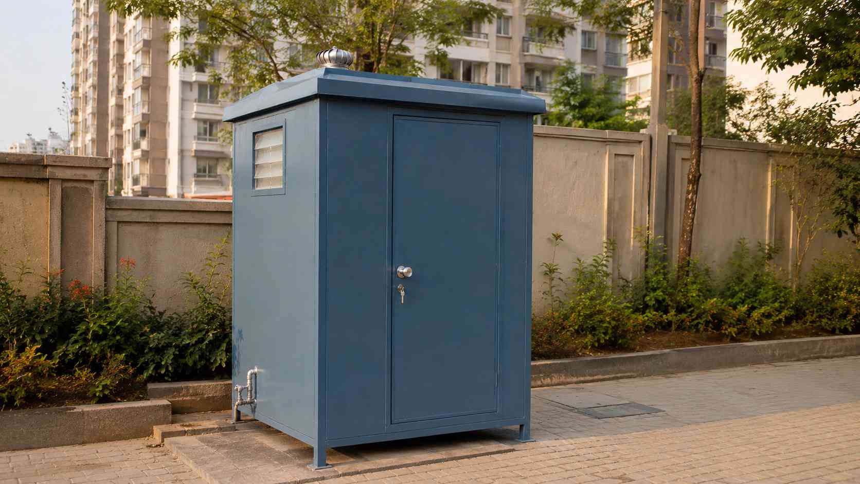 Steel blue prefabricated toilet installed at a residential society service area