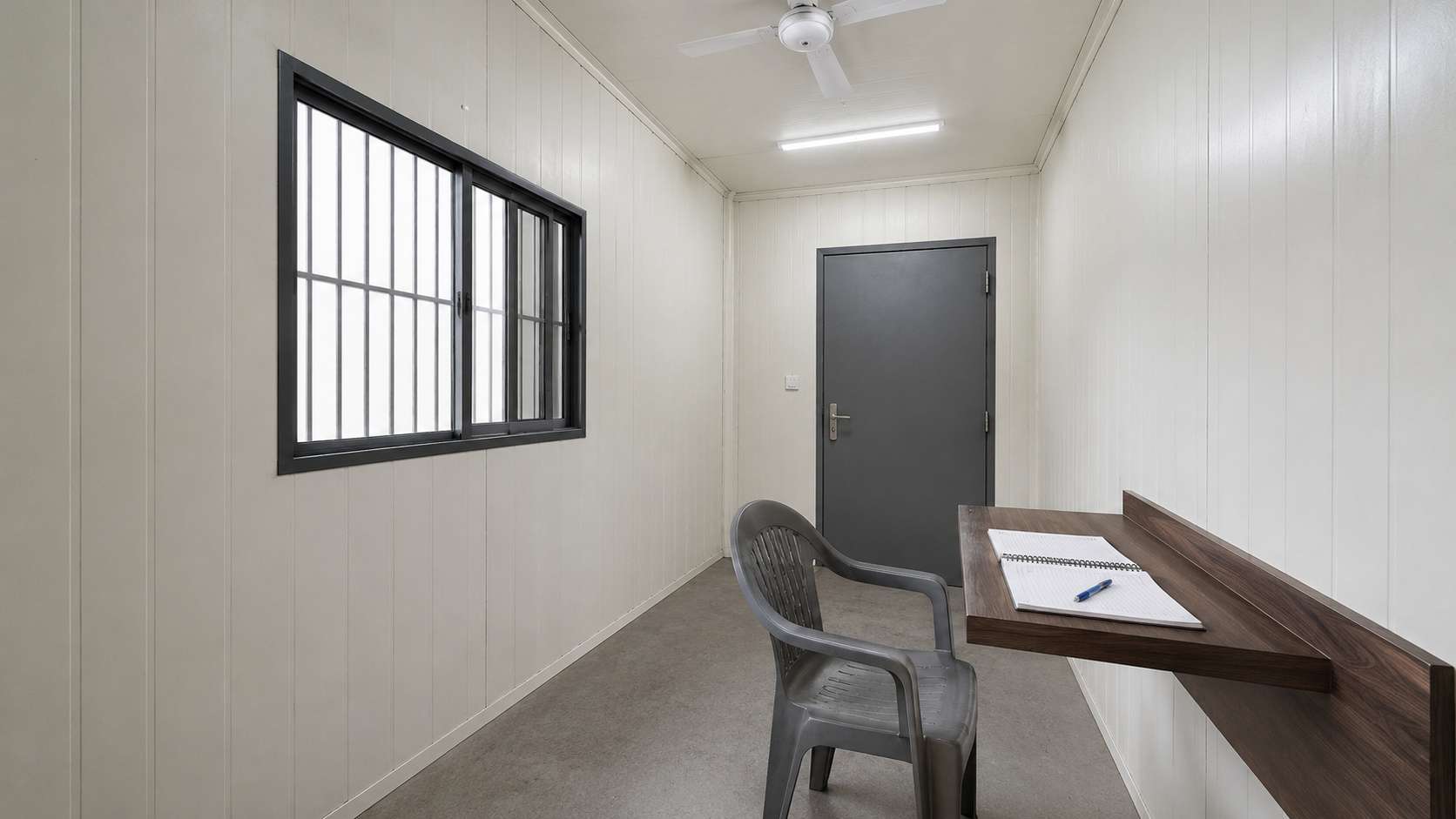 Interior of the SAMAN security guard cabin showing how a guard chair and register counter fit inside the 6×6 ft floor area