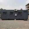 Slate charcoal 40-ft shipping container office side wall showing windows, AC condenser, and distribution box.