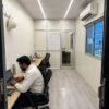 Container office cabin interior — false ceiling LED lighting, vinyl flooring, FRP wall panels, AC unit, partition wall, Indian site engineer