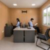 Interior of the small office cabin set up as a 2-person workspace with two desks and a visitor chair
