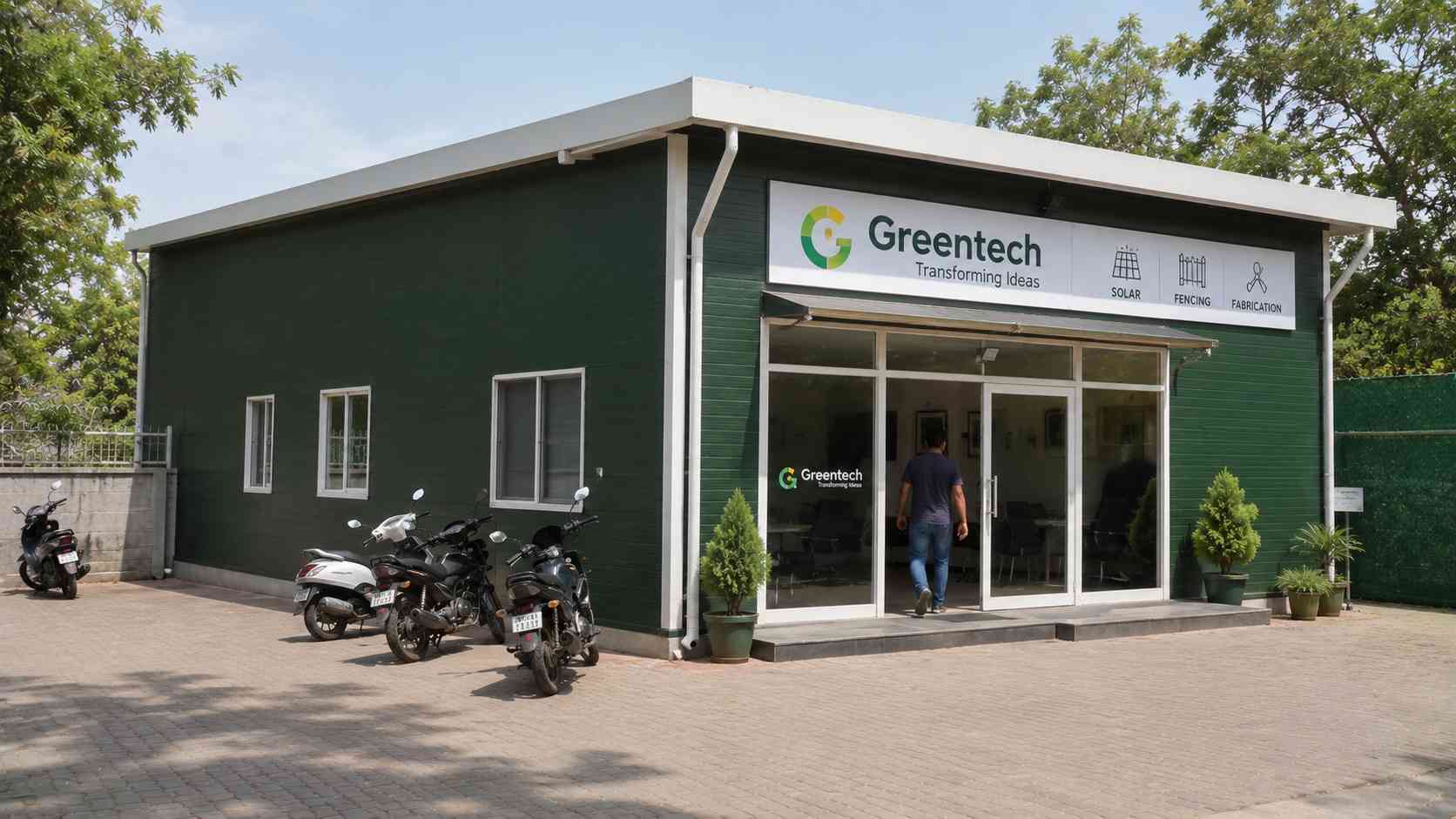 Forest green steel prefab building in use as a commercial unit with a glazed shopfront entrance.
