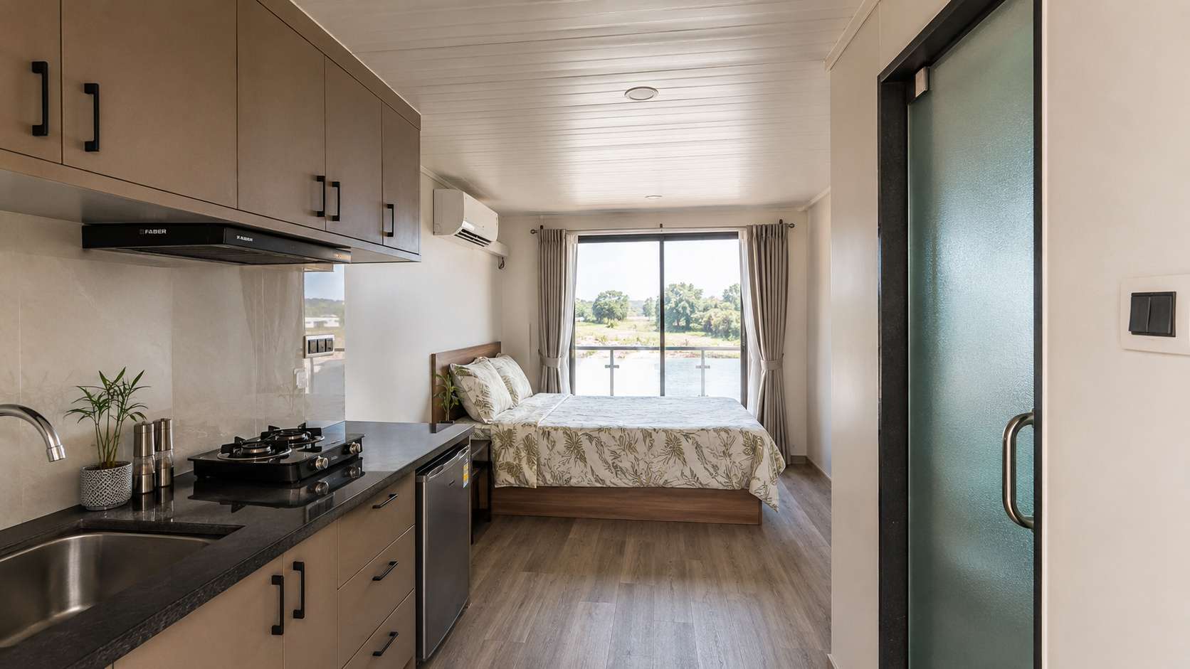 Compact interior layout of a SAMAN tiny container home showing kitchen, bedroom, and bathroom zones in a 160 sq ft living space