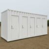 White toilet porta cabins with multiple compartments for site use