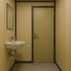 Interior view of toilet porta cabin with basin and door