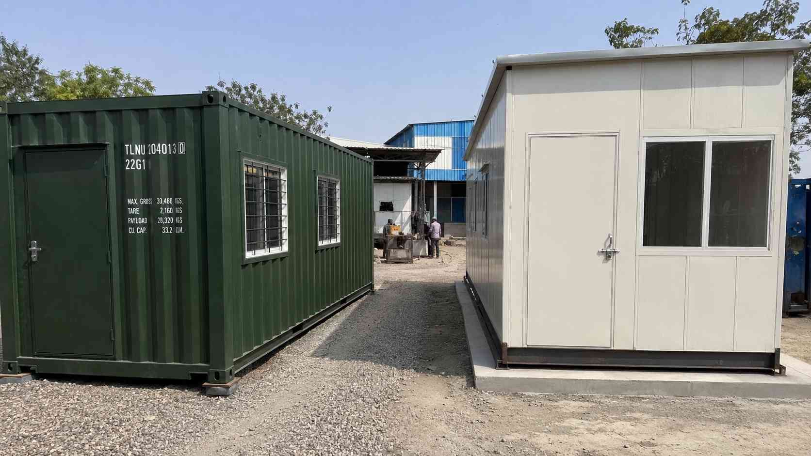 A Forest Green #2D4A2B container office next to an MS-framed portable cabin at an Indian industrial compound, illustrating where each fits in the budget.