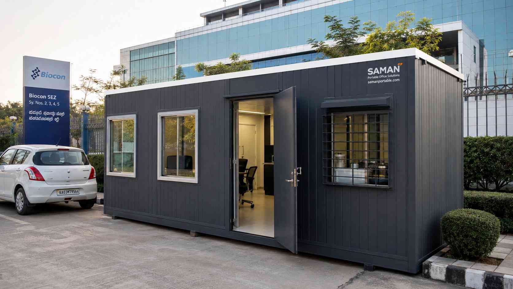 Charcoal grey SAMAN multi-room porta cabin deployed at a Biocon SEZ biotech-park plot in Bommasandra Phase 4