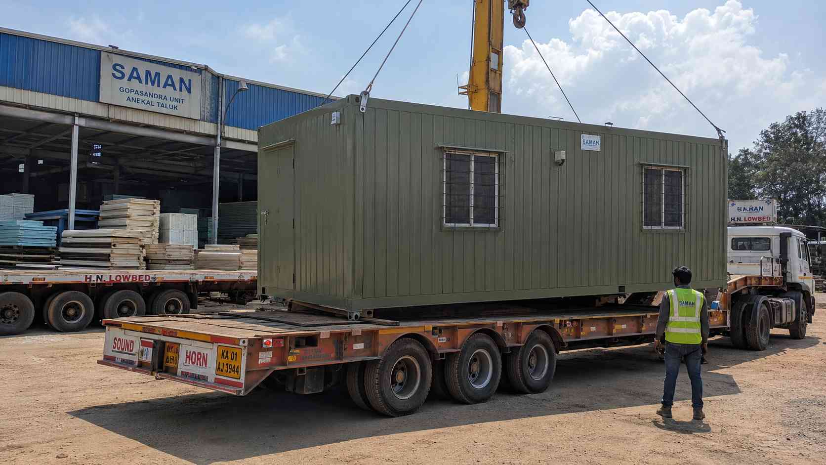 Sage Industrial porta cabin loaded onto a low-bed trailer at SAMAN's Gopasandra factory for Banashankari dispatch.