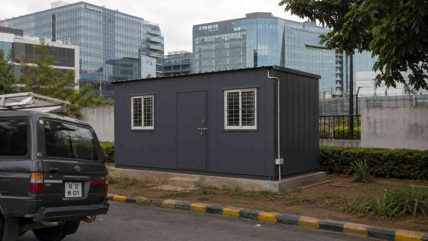 Slate Charcoal porta cabin installed as FM supervisor cabin inside an ORR tech-park perimeter in Bellandur Bengaluru.