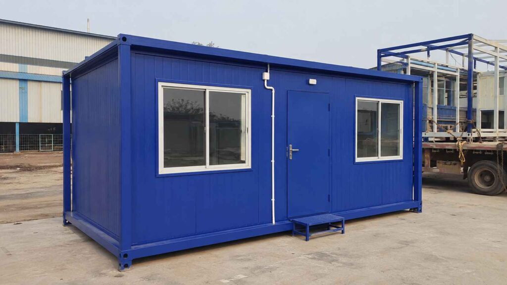 A Royal Cobalt blue porta cabin parked at SAMAN's Greater Noida factory yard ready for Delhi NCR delivery.