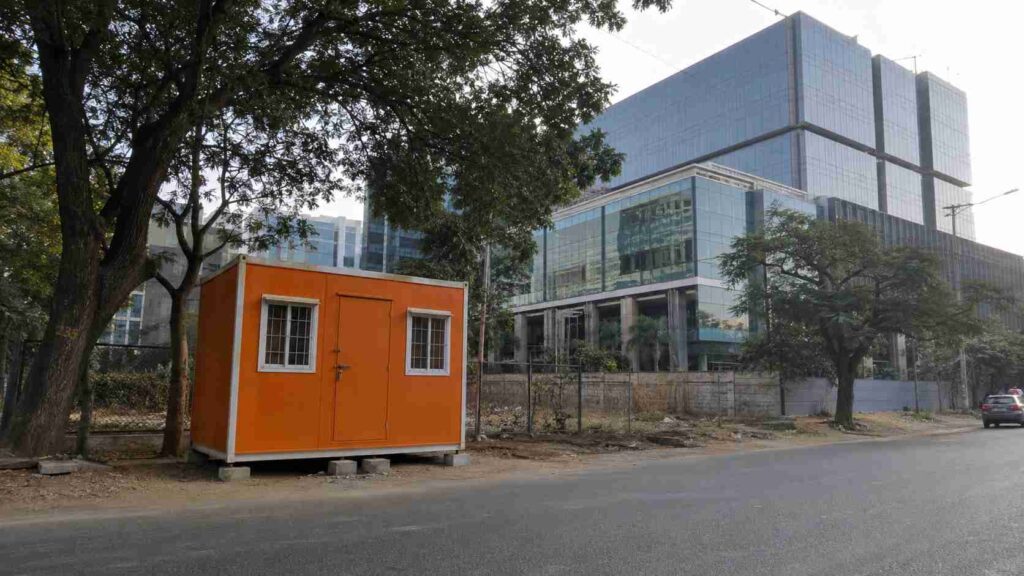 Safety Orange SAMAN porta cabin on Inner Ring Road frontage near Embassy Golf Links Business Park in Domlur, Bangalore.