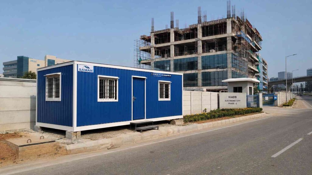 SAMAN NHAI Blue porta cabin on a KIADB Phase 2 plot in Electronic City near an under-construction IT campus.