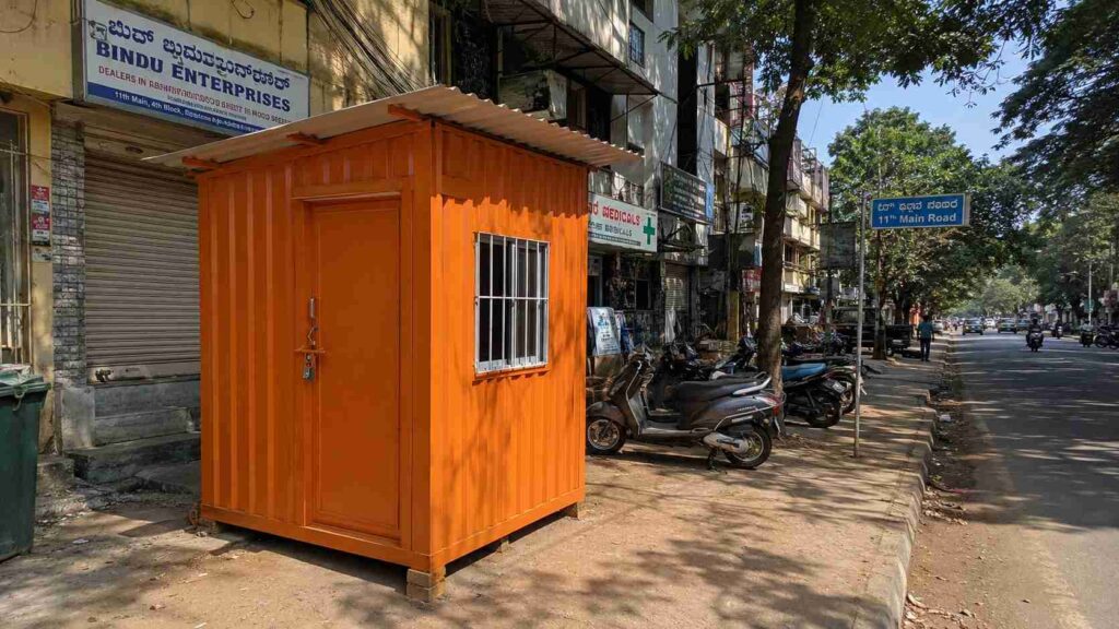 Safety Orange porta cabin installed on Jayanagar 4th Block 11th Main commercial spine, Bengaluru.