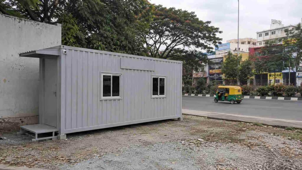 Pearl Grey MS porta cabin at an Outer Ring Road Nagarbhavi Circle commercial frontage site in Bangalore, with signage prep visible.