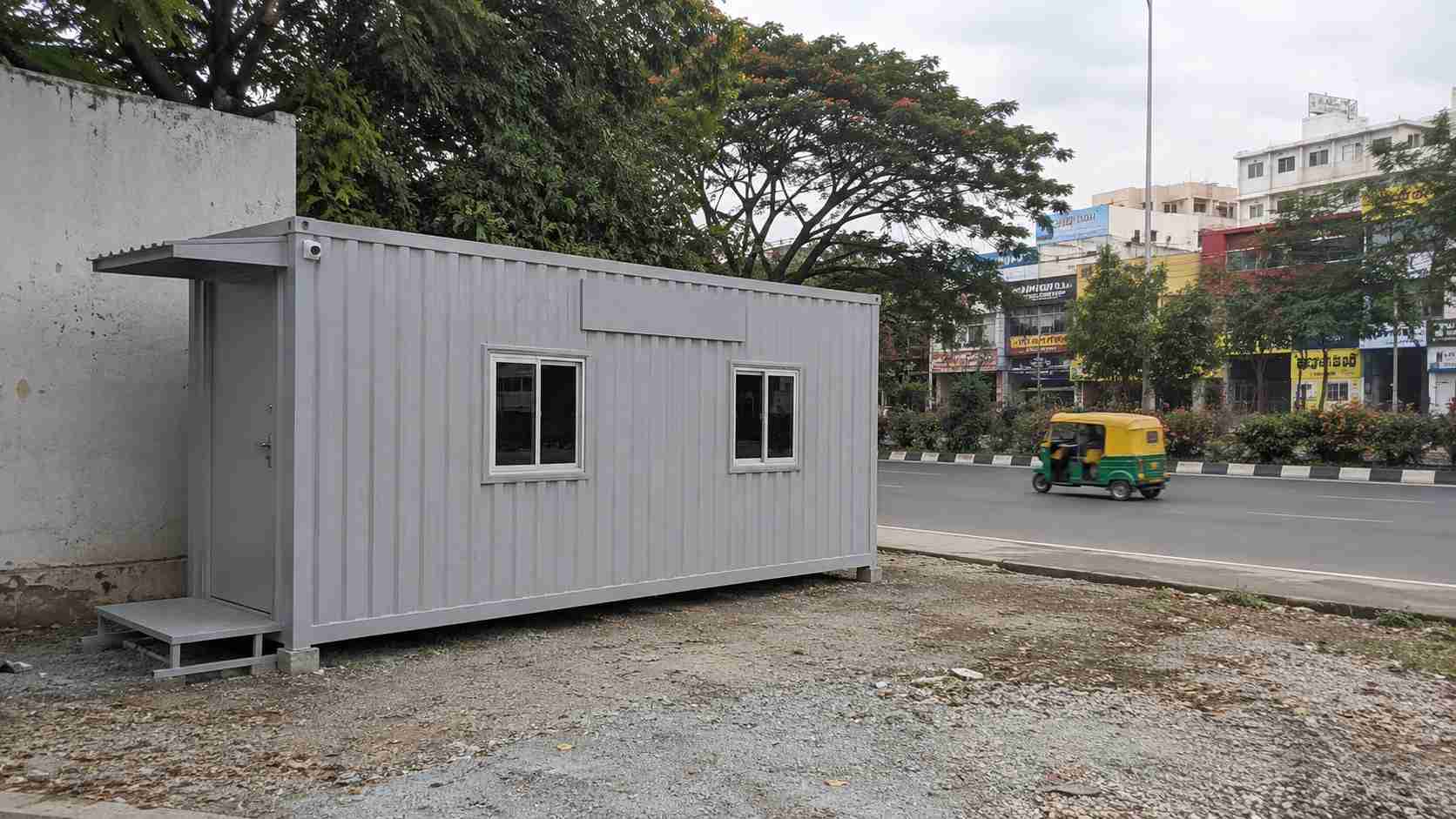 Pearl Grey MS porta cabin at an Outer Ring Road Nagarbhavi Circle commercial frontage site in Bangalore, with signage prep visible.