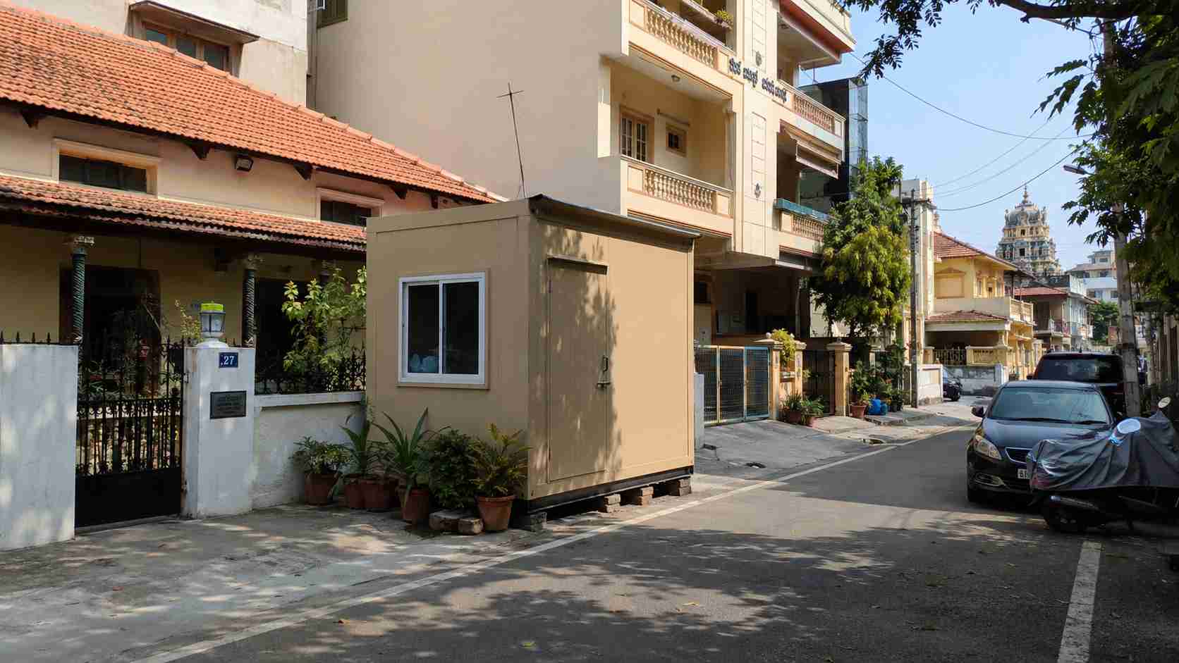 Sandstone Beige porta cabin on a Malleshwaram inner-cross residential plot near Kadu Malleshwara heritage precinct, neutral finish matching the neighbourhood.