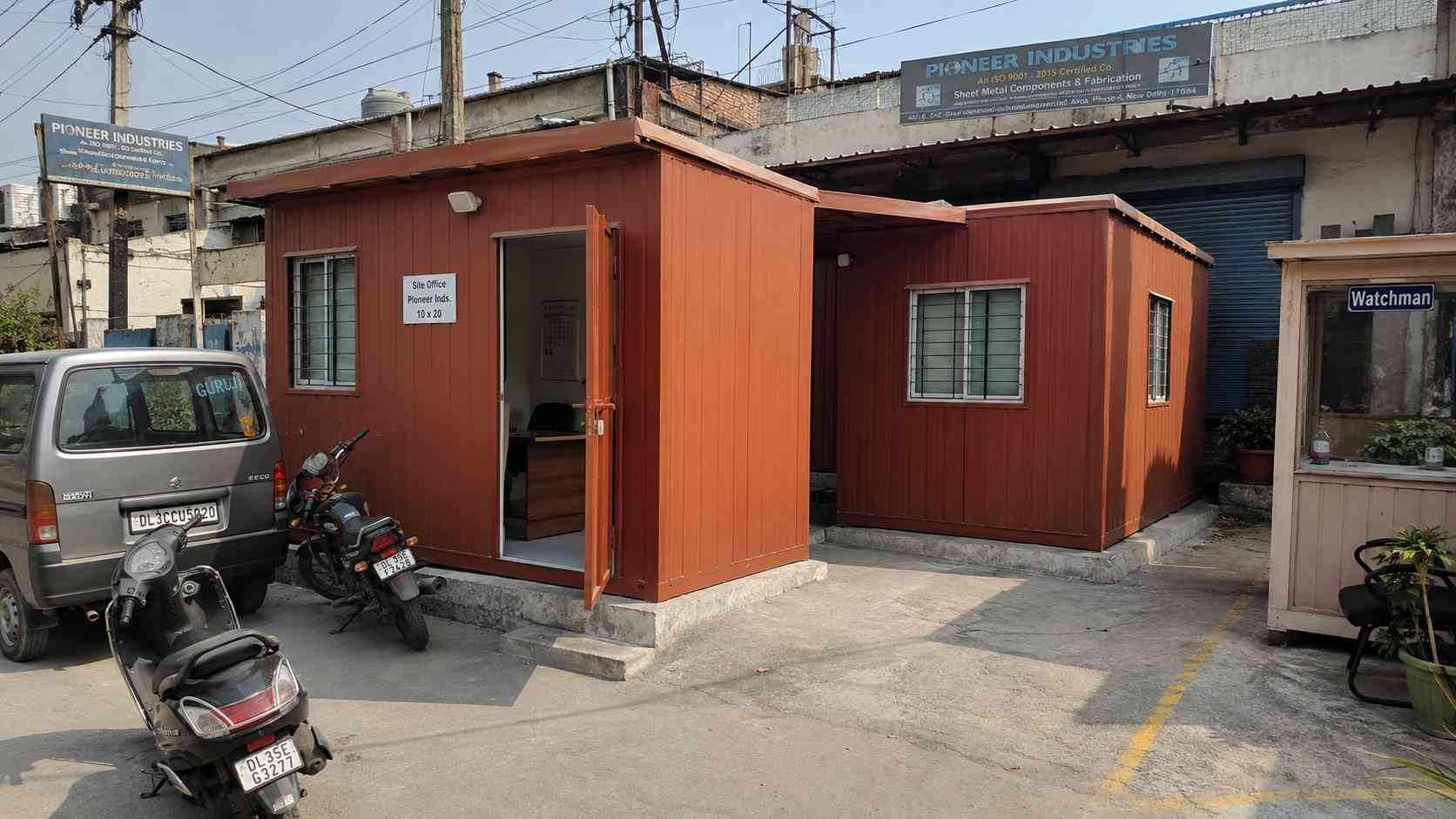 Brick Red multi-room porta cabin installed as an SME head office at a Mayapuri industrial estate in Delhi.