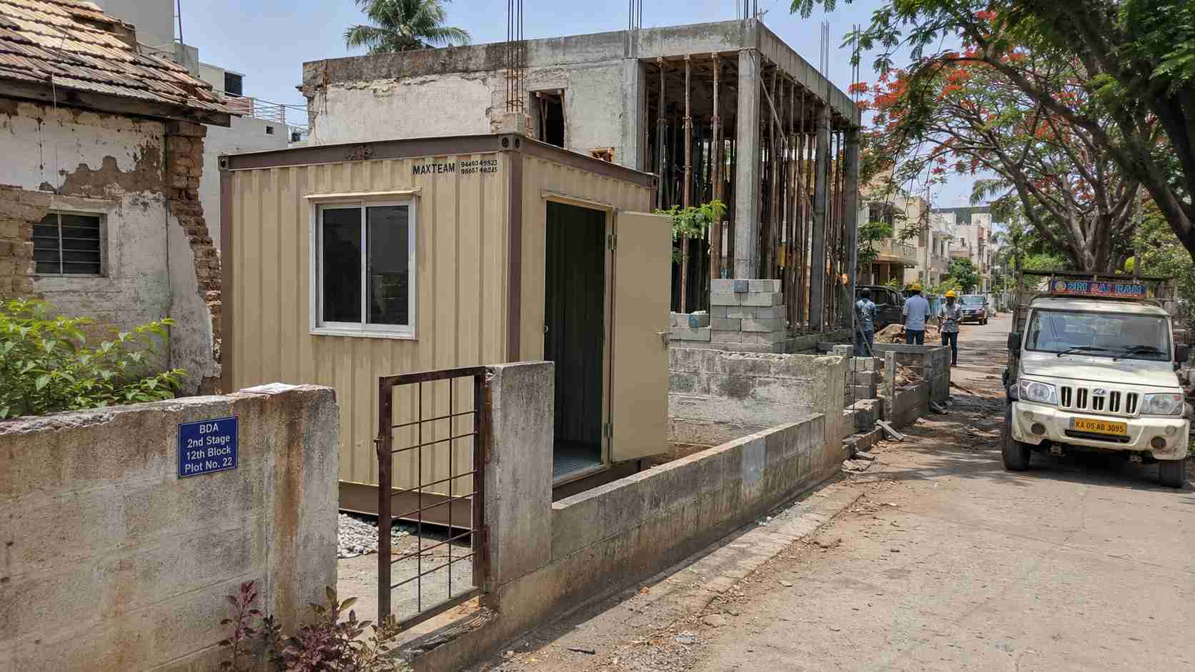 Royal Cobalt porta cabin at an NGEF or ITI Layout heritage-industrial pocket plot in Nagarbhavi serving a small fabrication unit, with secure access door visible.