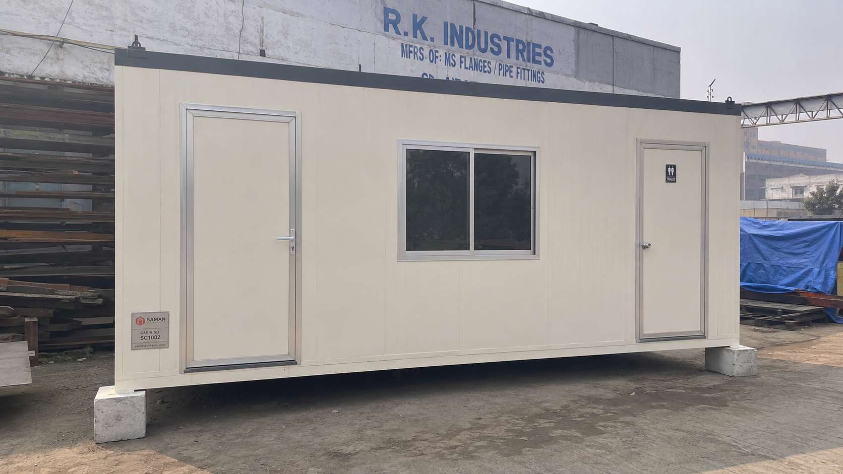 Cream White 10×20 ft porta cabin office with attached toilet — typical Delhi site office configuration.
