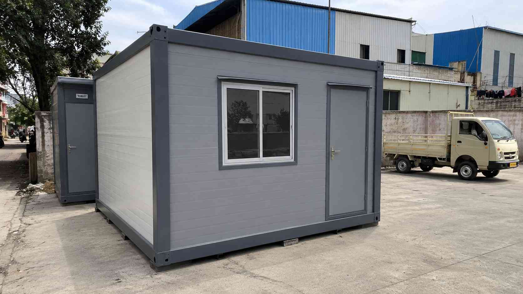 10×20 ft porta cabin office with attached toilet in Steel Grey, KR Puram SME compound installation showing real spec floor.