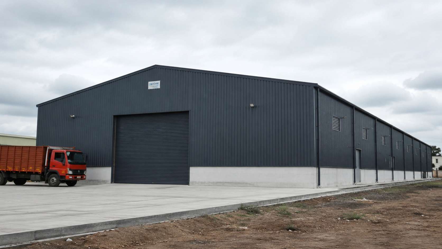 Completed Slate Charcoal PEB steel warehouse built by SAMAN on an Indian industrial site.