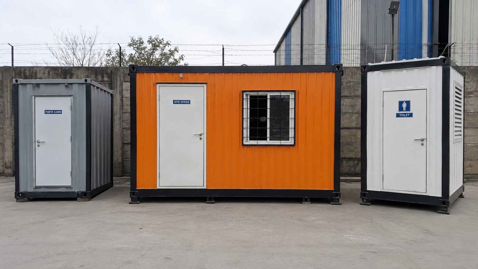 Three porta cabin types together — mini, site office in Safety Orange, and sanitation unit on a yard.