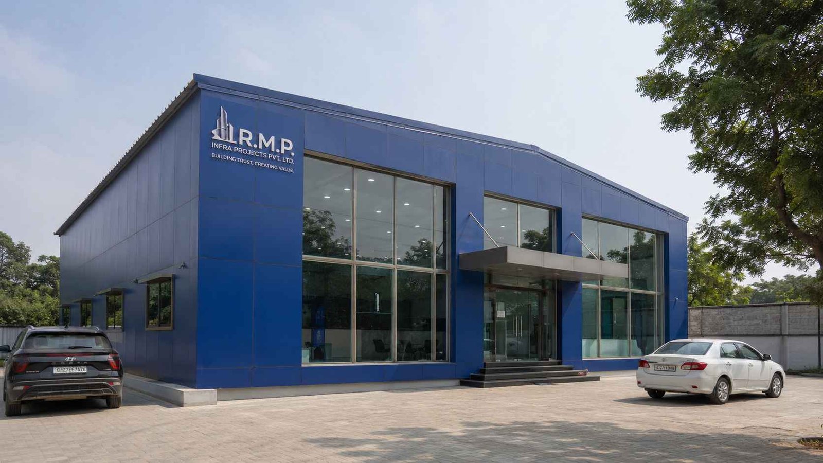 Royal cobalt prefab commercial building with glass facade and steel canopy entrance in India.