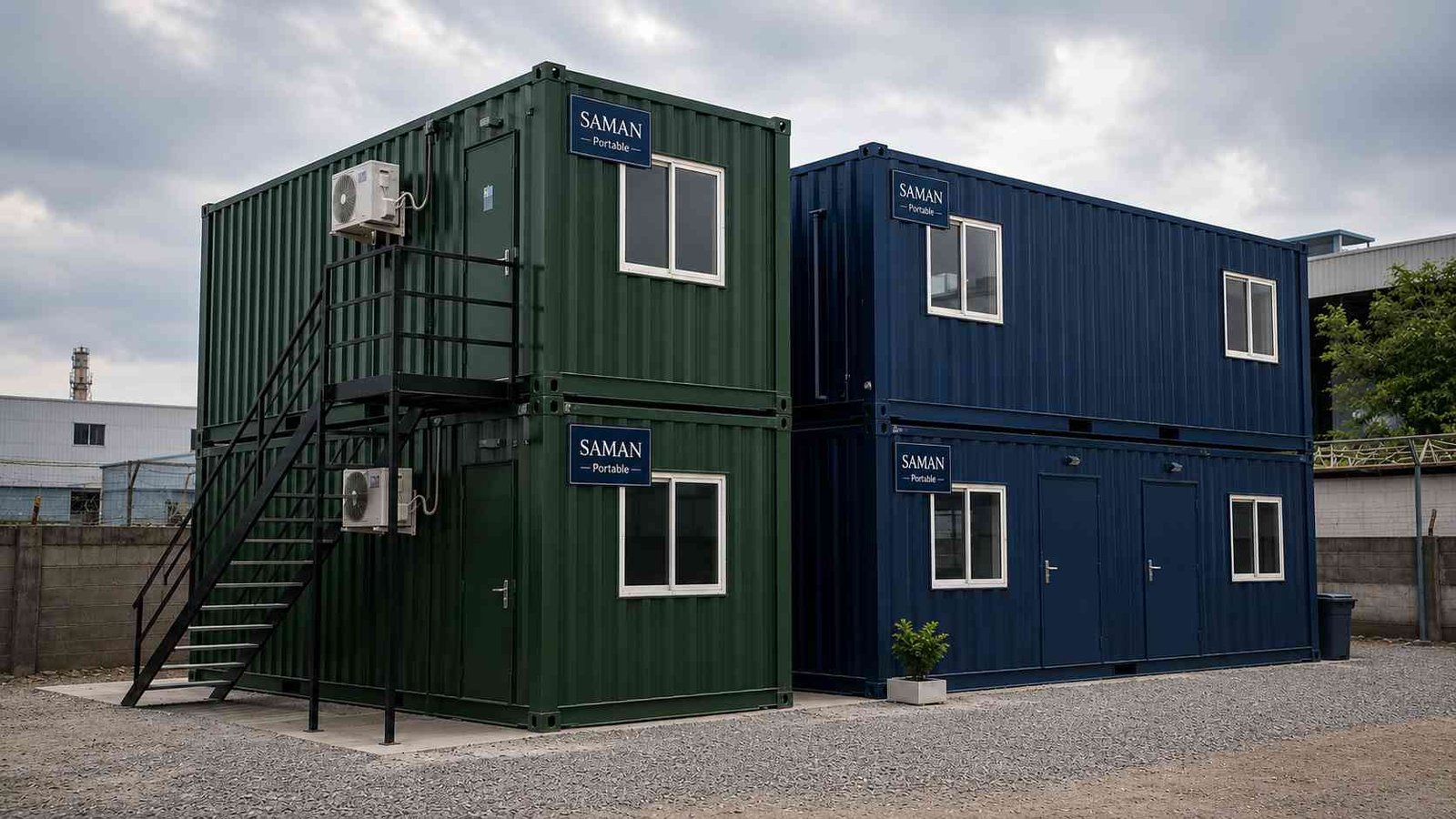Two-level forest green and navy container offices stacked at an industrial park, showing the container form factor.
