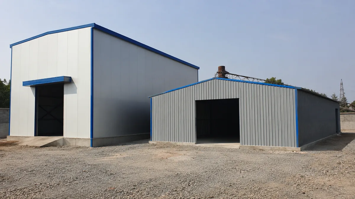 Tall insulated warehouse shed next to a shorter sheet-clad storage shed showing different industrial shed types