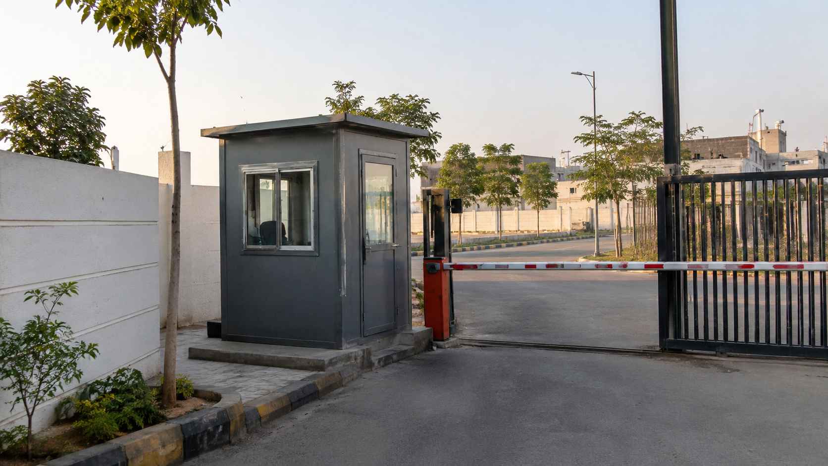 Compact steel security porta cabin at a Yelahanka gated layout entrance in Yelahanka New Town